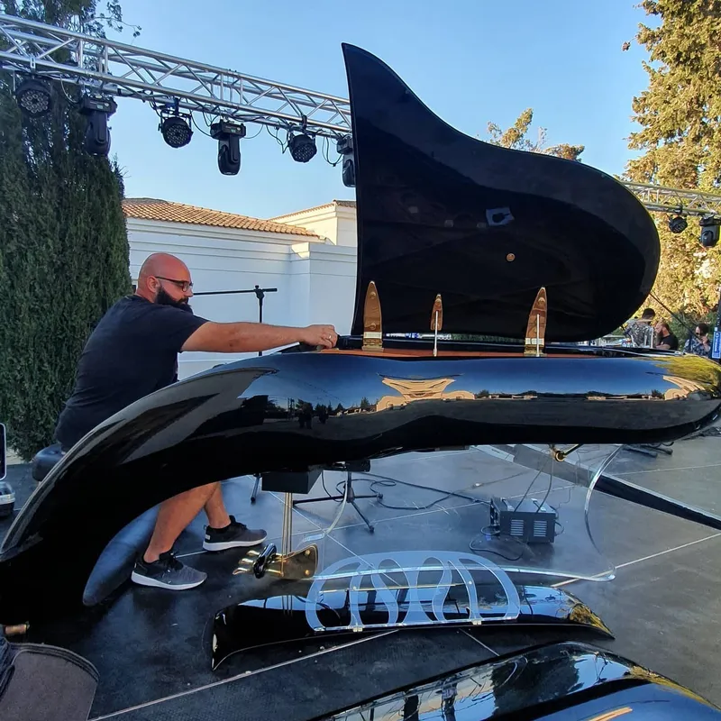 Tuning a grand piano on an outdoor stage in Cyprus