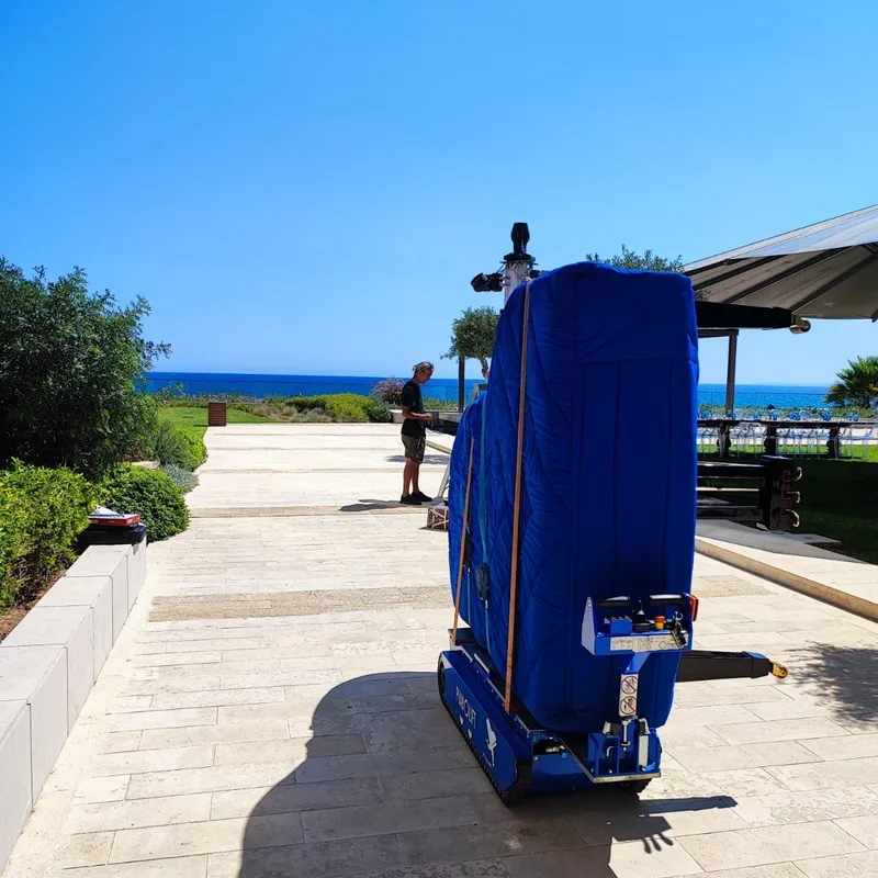 A piano being moved to a seaside venue